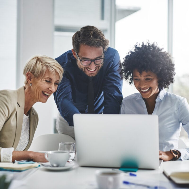 Laptop, collaboration and business people in the office while working on a company project. Technology, teamwork and team doing corporate research in discussion together with technology in workplace